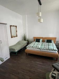a bedroom with a bed and a mirror at Ruhrpott Liebe in Herten