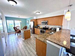 a kitchen with wooden cabinets and a counter top at 2BR/1BA Sienna Park Apartment in Sarasota