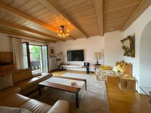 a living room with a couch and a table at Haus Lukaswinkl in Schönau am Königssee