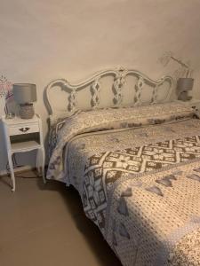 a bedroom with a bed and a nightstand with two lamps at Casetta sul Porto in Imperia