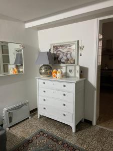 a white dresser with a microwave on top of it at Casetta sul Porto in Imperia