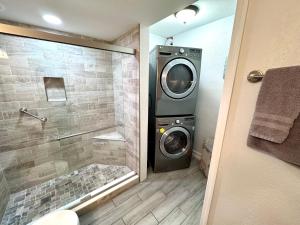 a bathroom with a washing machine in a shower at 2BR/1BA Sienna Park Apartment in Sarasota +26 photos