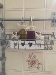 a shelf on a wall with bottles and boxes at Casetta sul Porto in Imperia