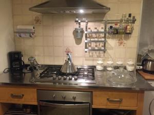 a kitchen with a stove with a tea kettle on it at Casetta sul Porto in Imperia +32 photos
