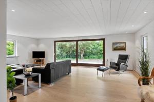 a living room with a couch and chairs at 80324-Ulfborg-Munkhulevej-6 in Staby