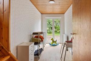 a living room with a table and a window at 80324-Ulfborg-Munkhulevej-6 in Staby
