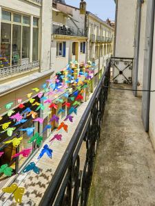 a group of colorful kites sitting on the side of a building at Le Citadin - Centre - Wifi - Balcon in Dax