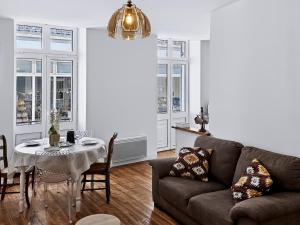 a living room with a couch and a table at Le Citadin - Centre - Wifi - Balcon in Dax +30 photos