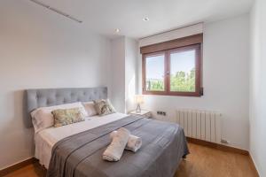 a bedroom with a large bed and a window at VILLA TAZA DE PLATA A in Huétor Vega +98 photos