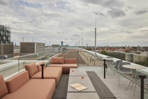 a balcony with couches and tables on a building at Locke at East Side Gallery in Berlin +16 photos