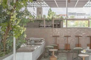 an outdoor patio with stools and tables in a building at Locke at East Side Gallery in Berlin