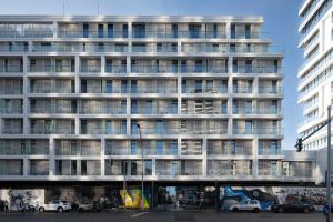 a tall building with cars parked in front of it at Locke at East Side Gallery in Berlin