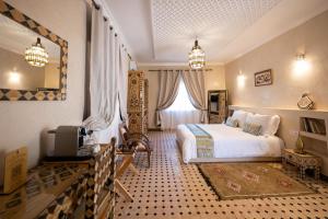 a bedroom with a bed and a tv in a room at Villa du Cedre in Marrakesh +131 photos