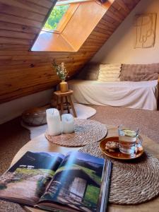 a room with a table with a book and a drink at Riviera Lodge II in Allos
