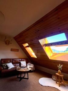 a living room with a couch and a window at Riviera Lodge II in Allos