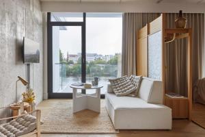 a living room with a white couch and a table at Locke at East Side Gallery in Berlin