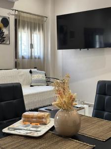 a living room with a couch and a table at Stv Royal Appartments in Areopoli