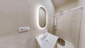 a white bathroom with a sink and a mirror at Lobster Room - Estrela do Mar - 1 in Albufeira