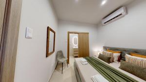 a small room with a bed and a mirror at Lobster Room - Estrela do Mar - 1 in Albufeira