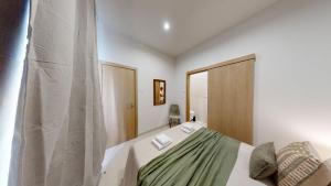 a bedroom with a bed and a mirror at Lobster Room - Estrela do Mar - 1 in Albufeira