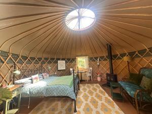 a room with a bed and a table in a yurt at Thistlebank Yurt in Llangollen