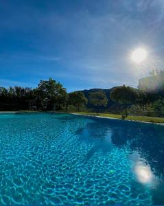 a large pool of water with the sun in the background at Coto del Valle de Cazorla in Cazorla