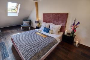 a bedroom with a large bed and a chair at Luxury Heaven Apartment - 116 m2 Fireplace 3 bedroom - Free Parking in Katowice