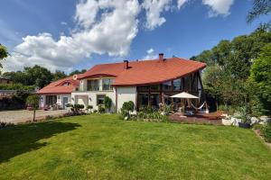 a house with a red roof and a yard at Luxury Heaven Apartment - 116 m2 Fireplace 3 bedroom - Free Parking in Katowice