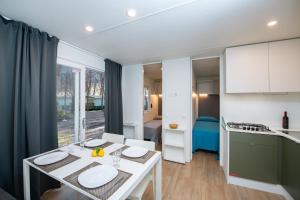 a kitchen with a table with two plates on it at Camping Iscrixedda in Lotzorai