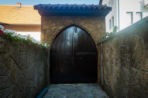 a large wooden door in a stone wall at AG Apartmans in Gornji Vakuf