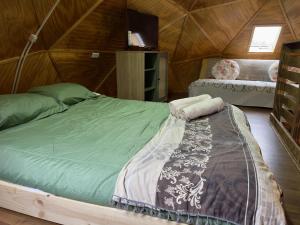 a bedroom with a large bed in a wooden room at Oceana Suites Coyhaique in Puerto Dunn