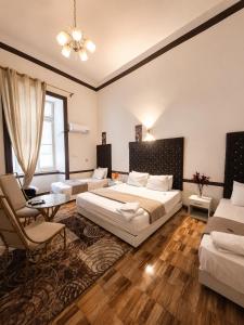 a bedroom with two beds and a couch and a table at Velvet city view in Cairo +8 photos