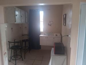 a small kitchen with a table and stools in it at Studio comodo con aire acondicionado in Caguas