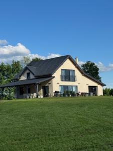 a house with a large lawn in front of it at Pod Skrzydłami II in Liksajny
