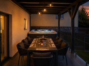 a restaurant with a table and a bath tub at Cataleya House Sovata in Sovata +16 photos