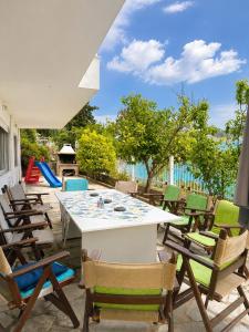 a patio with chairs and a table and a playground at ENDLESS BLUE WAVE in Paleo Tsifliki