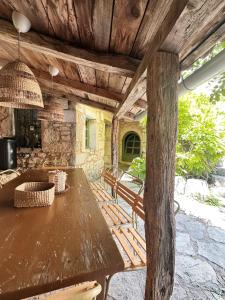 a wooden table and chairs on a patio at Authentic Stone House Tranquil Villa for Families and Groups in Grižane