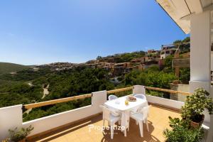 a balcony of a villa with a table and a view at Il terrazzo sulla duna 6 by Propertize in Torre Dei Corsari