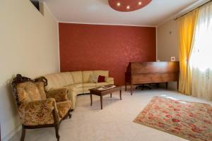 a living room with a piano and a couch at Bed & Breakfast Isola Bella Lampedusa in Lampedusa