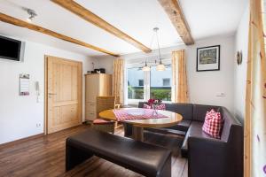 a living room with a couch and a table at Ferienhof Pohl-Optimal für Familien in Lennestadt