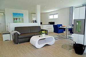 a living room with a couch and a table at Sturmvogel in Olpenitz