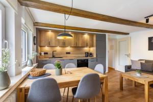 a kitchen and dining room with a wooden table and chairs at Ferienhof Riekeshof in Schmallenberg
