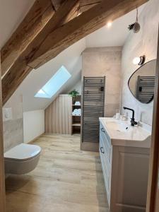 a bathroom with two sinks and a toilet in a attic at Le Nid - Pause en Berry in Vignoux-sur-Barangeon +25 photos