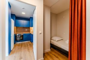 a small bedroom with blue cabinets and a bed at Apartment for 5 with a forest view in La Teste-de-Buch
