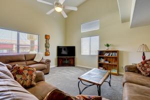 a living room with couches and a flat screen tv at Golf & Gamble! Mesquite Condo w/ Pool Access in Mesquite