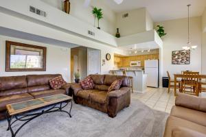 a living room with a couch and a table at Golf & Gamble! Mesquite Condo w/ Pool Access in Mesquite