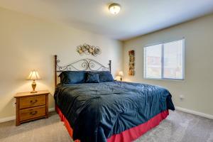 a bedroom with a large bed and a window at Golf & Gamble! Mesquite Condo w/ Pool Access in Mesquite