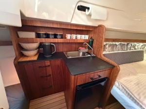 a small kitchen with a sink and a bed at Golden Yacht Solina in Polańczyk +10 photos