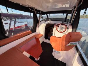 an inside view of a boat with orange seats at Golden Yacht Solina in Polańczyk