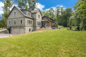 a large house with a lawn in front of it at The Summit Estate in Boyne Falls